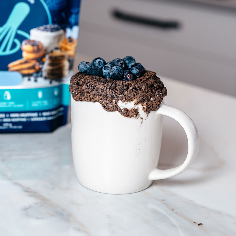 Blueberry vanilla mug cake topped with blueberries