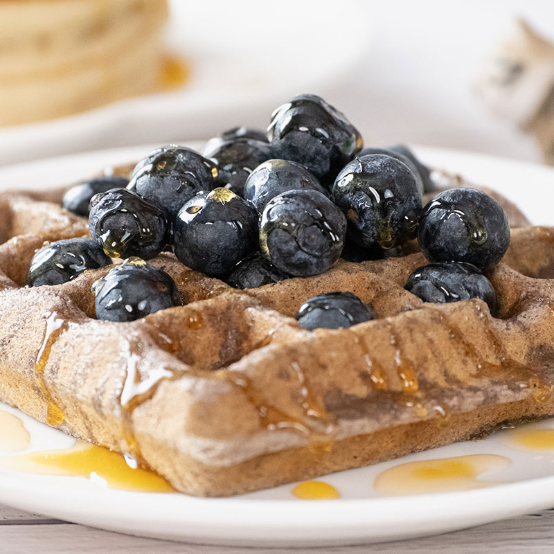 Blueberry vanilla waffle topped with blueberries and syrup